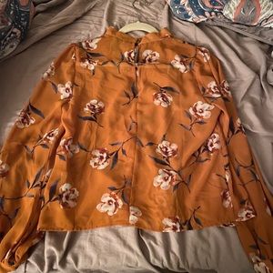 Orange floral top with cute neck!